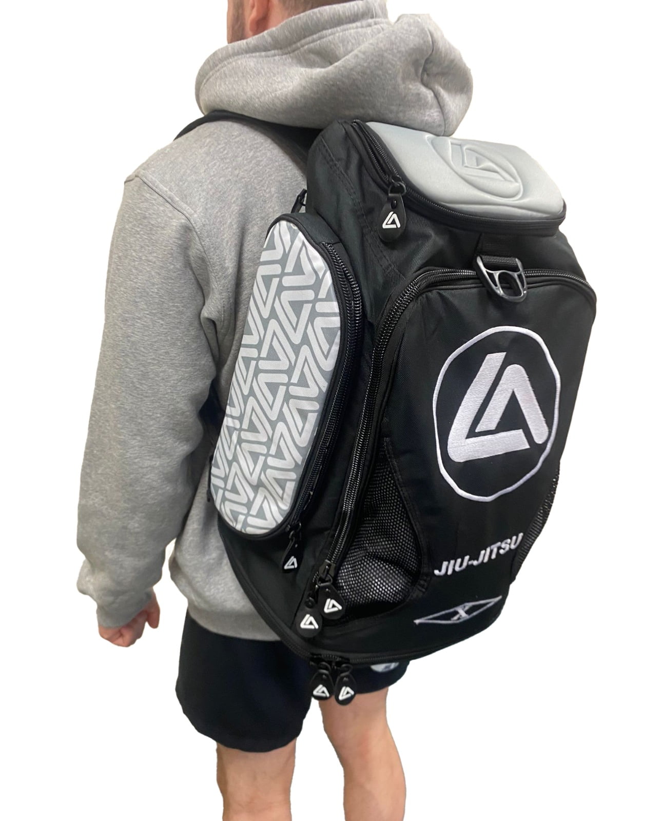 the side-rear view of a roger gracie branded backpack